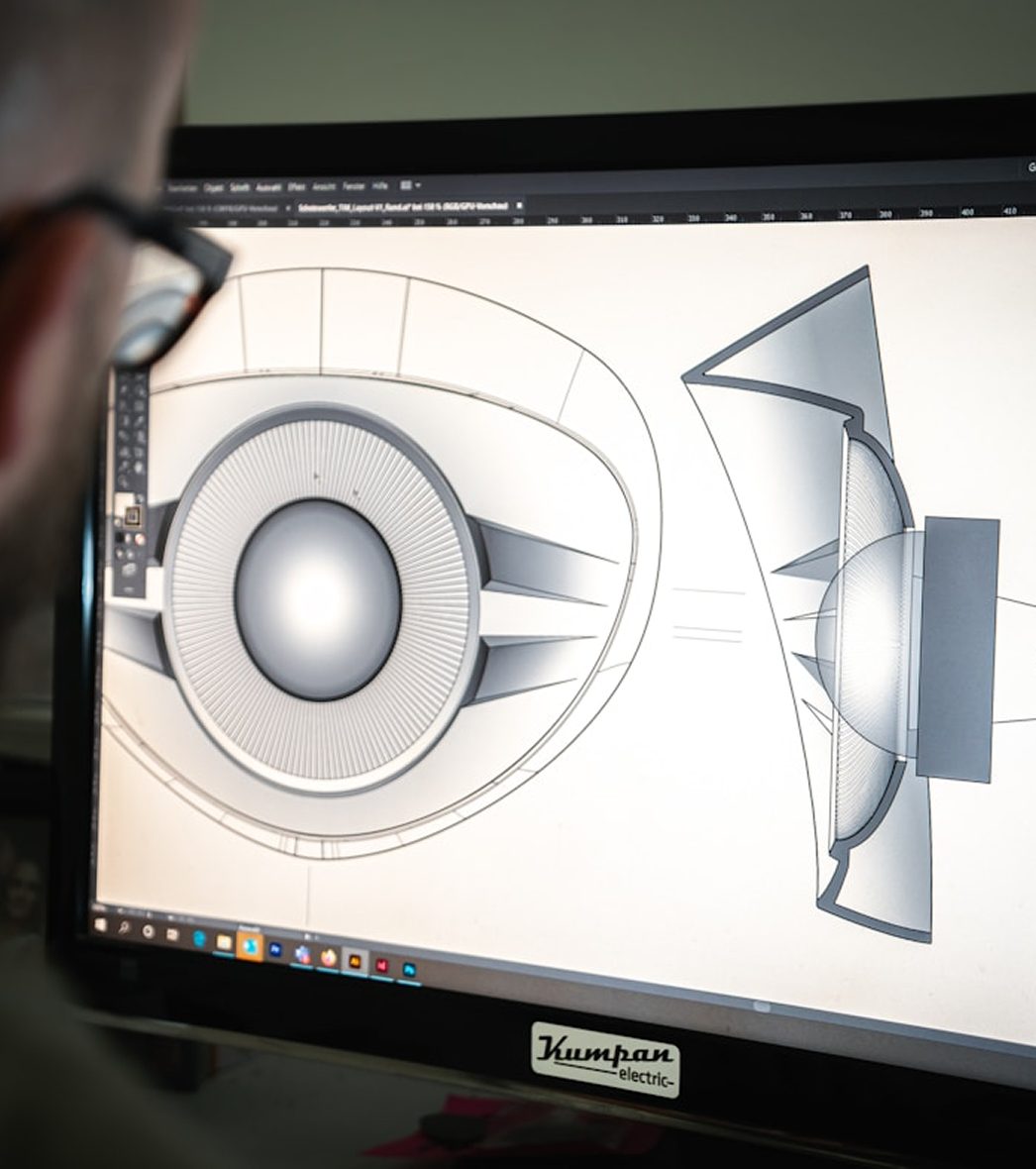 A modelling application open on a studio monitor, mid-render.
